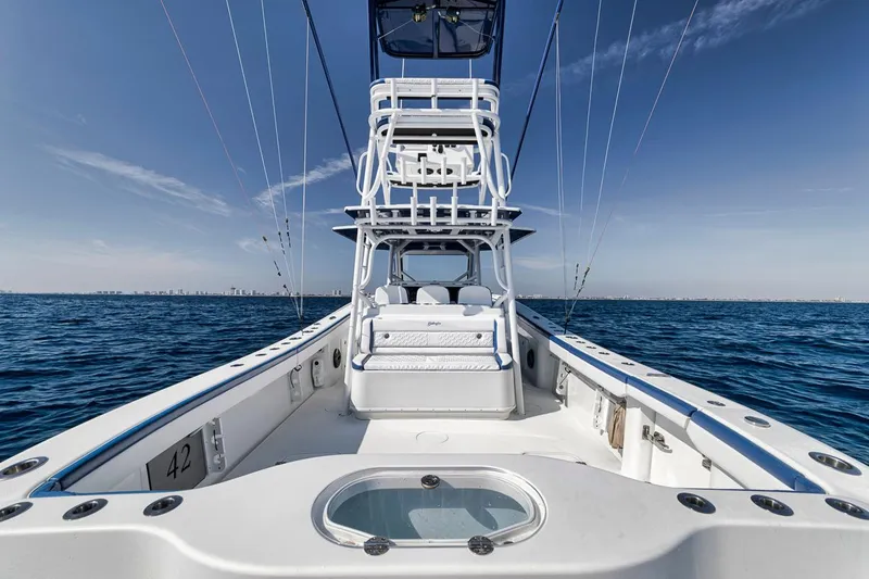 Slide: The Image of 2020 Yellowfin 42 Offshore boat on open sea, showcasing spacious deck and tower. - 26