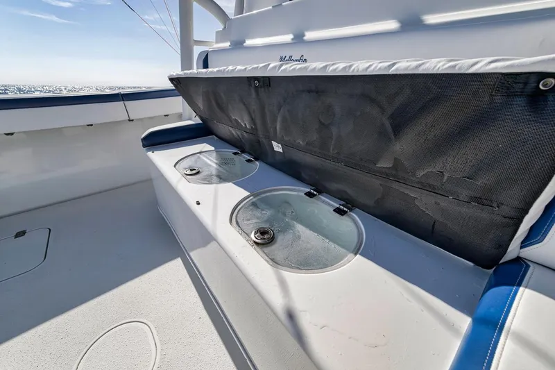 Slide: The Image of 2020 Yellowfin 42 Offshore boat with open storage compartment and seating area. - 28