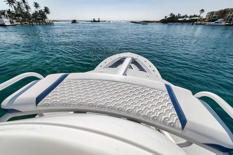 Slide: The Image of 2020 Yellowfin 42 Offshore boat on serene blue water with palm trees in the background. - 33