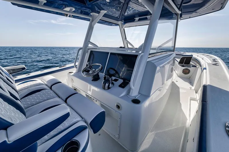 Slide: The Image of 2020 Yellowfin 42 Offshore boat interior with ocean view, featuring modern helm and seating. - 40