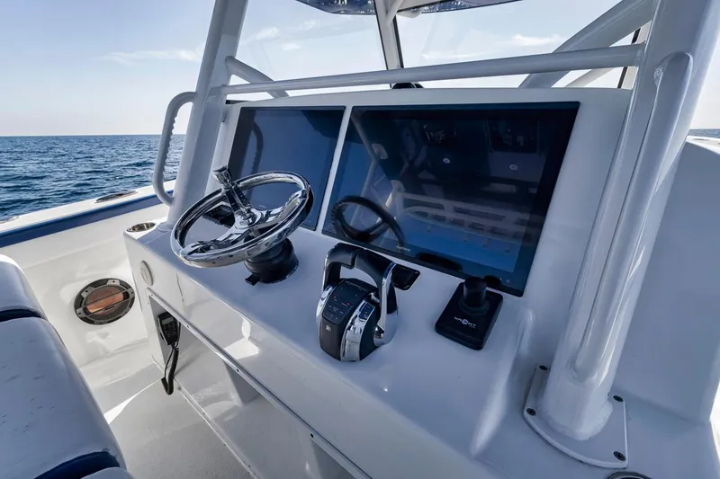 Slide: The Image of 2020 Yellowfin 42 Offshore boat helm with dual screens and steering wheel. - 42