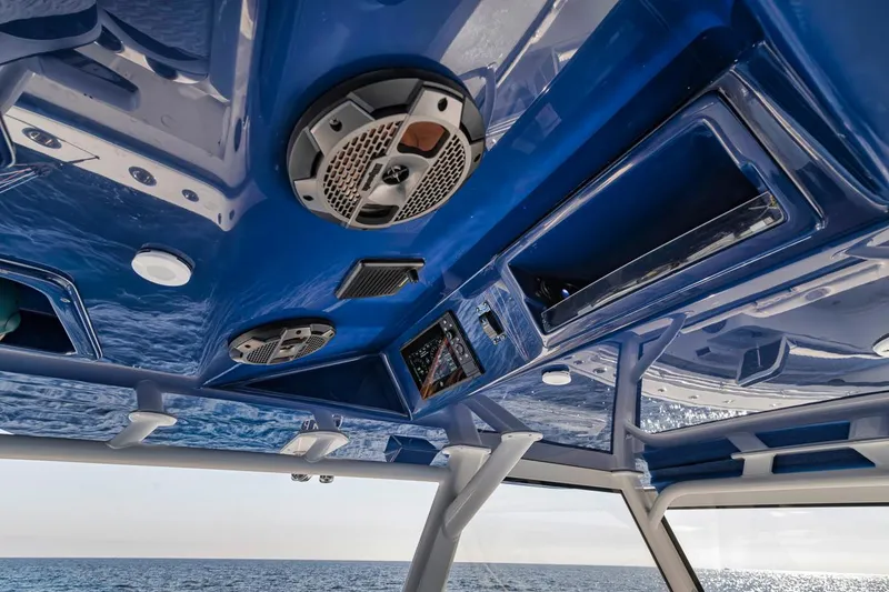 Slide: The Image of 2020 Yellowfin 42 Offshore boat interior with blue ceiling and speakers. - 43