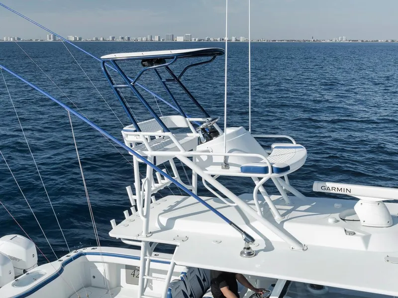 Slide: The Image of 2020 Yellowfin 42 Offshore boat with tower, ocean view, and city skyline in background. - 6