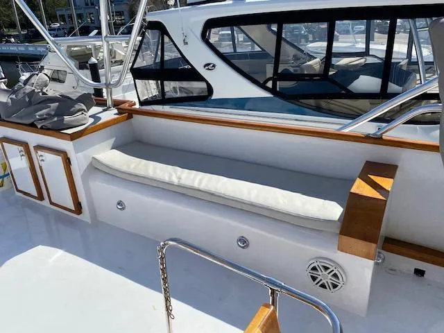 Slide: The Image of 1971 Matthews Motor Yacht deck with cushioned seating and wooden accents. - 10