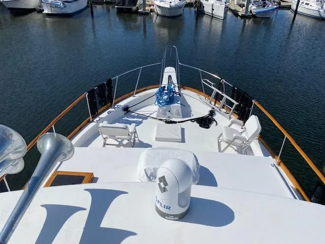 Slide: The Image of 1971 Matthews Motor Yacht docked, featuring spacious deck and seating area. - 11