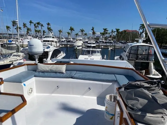 Slide: The Image of 1971 Matthews Motor Yacht docked at marina, featuring spacious deck with seating and clear skies. - 12