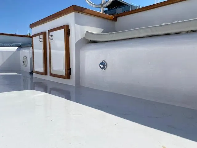 Slide: The Image of 1971 Matthews Motor Yacht deck with wooden accents and storage compartments. - 16