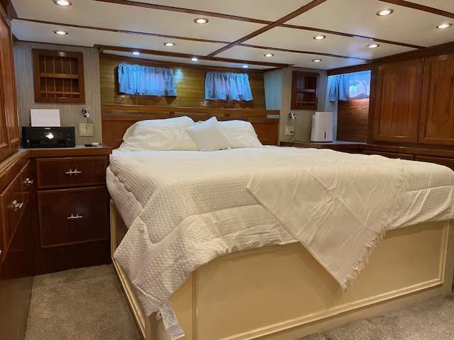 Slide: The Image of Luxurious bedroom interior of a 1971 Matthews Motor Yacht with elegant wood paneling. - 17