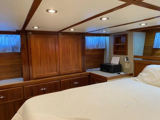 Slide: The Image of 1971 Matthews Motor Yacht interior with wood paneling and cozy bedroom. - 18