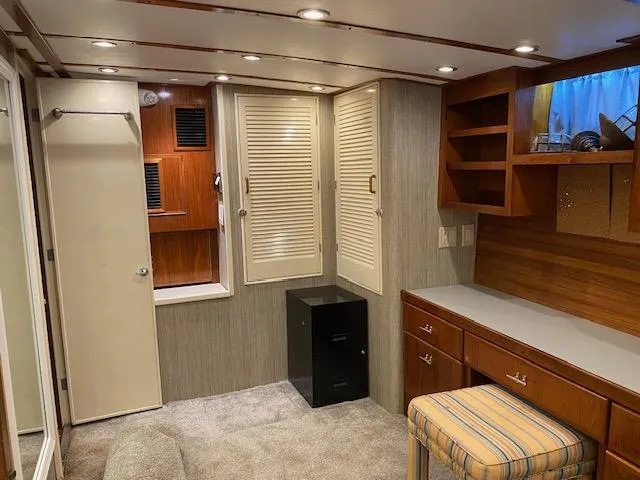 Slide: The Image of Interior of a 1971 Matthews Motor Yacht with wood cabinetry and cozy seating. - 19