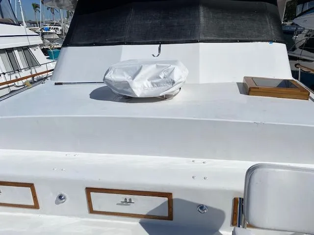 Slide: The Image of 1971 Matthews Motor Yacht deck with covered equipment and wooden accents. - 21