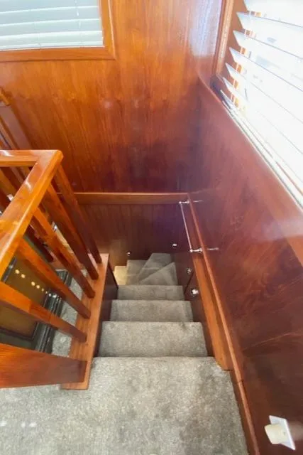 Slide: The Image of Staircase inside 1971 Matthews Motor Yacht with wooden paneling and carpeted steps. - 22