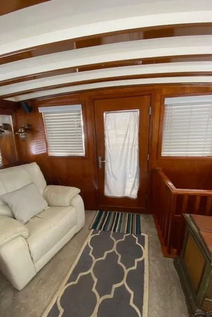 Slide: The Image of Interior of 1971 Matthews Motor Yacht with wooden paneling and comfortable seating. - 23