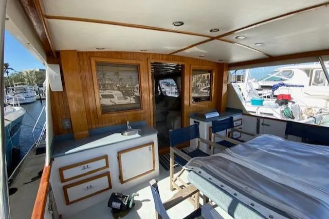Slide: The Image of 1971 Matthews Motor Yacht interior with wood paneling and marina view. - 24