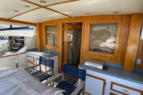 Slide: The Image of 1971 Matthews Motor Yacht interior with wood paneling and seating area. - 28