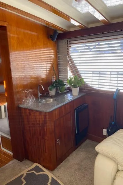 Slide: The Image of 1971 Matthews Motor Yacht interior with wooden cabinetry, sink, and potted plants. - 29