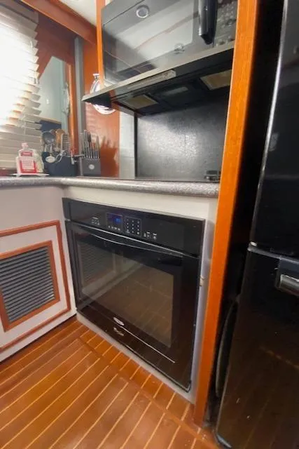 Slide: The Image of 1971 Matthews Motor Yacht kitchen with modern appliances and wood flooring. - 35