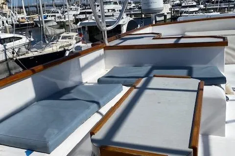 Slide: The Image of 1971 Matthews Motor Yacht deck with cushioned seating, docked at a marina. - 36