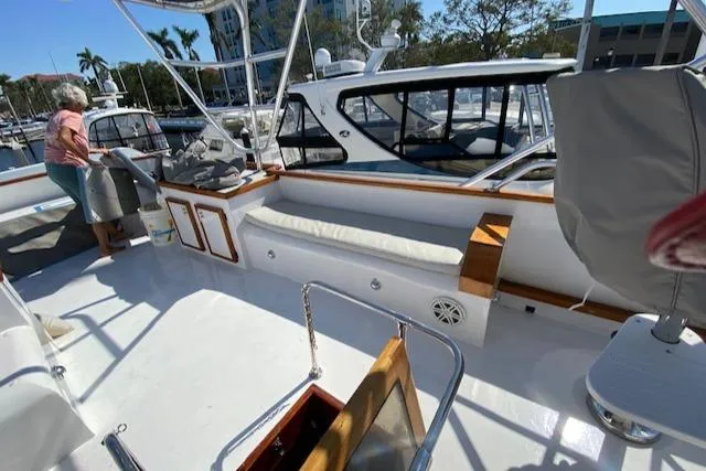 Slide: The Image of 1971 Matthews Motor Yacht deck with seating, docked at marina under sunny skies. - 37
