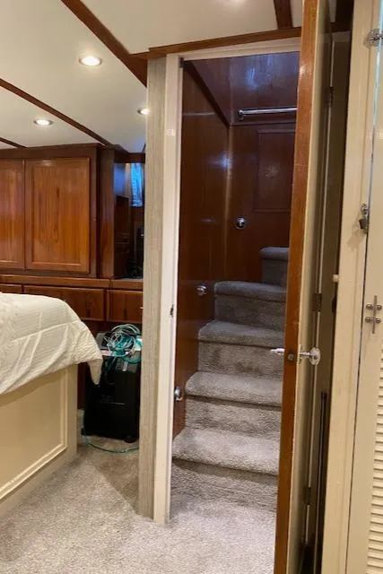 Slide: The Image of Interior of a 1971 Matthews Motor Yacht with wooden paneling and carpeted stairs. - 38