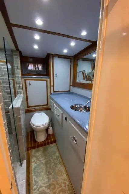 Slide: The Image of 1971 Matthews Motor Yacht bathroom with modern fixtures and wood accents. - 40