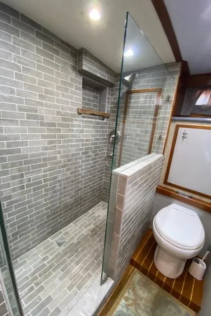 Slide: The Image of Luxurious bathroom in a 1971 Matthews Motor Yacht with glass shower and modern fixtures. - 41