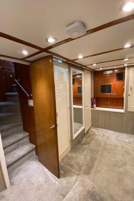 Slide: The Image of Interior of a 1971 Matthews Motor Yacht with wood paneling and carpeted flooring. - 42