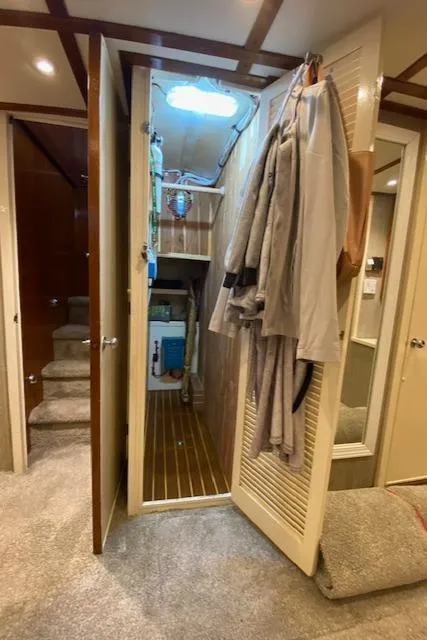 Slide: The Image of Interior of a 1971 Matthews Motor Yacht with open closet and carpeted flooring. - 43