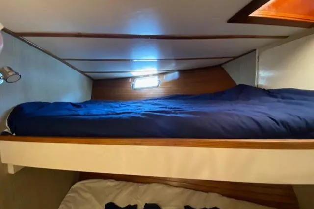 Slide: The Image of 1971 Matthews Motor Yacht cabin with bunk beds and wooden interior. - 48