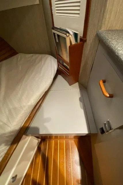 Slide: The Image of 1971 Matthews Motor Yacht interior with wooden flooring and compact storage. - 49