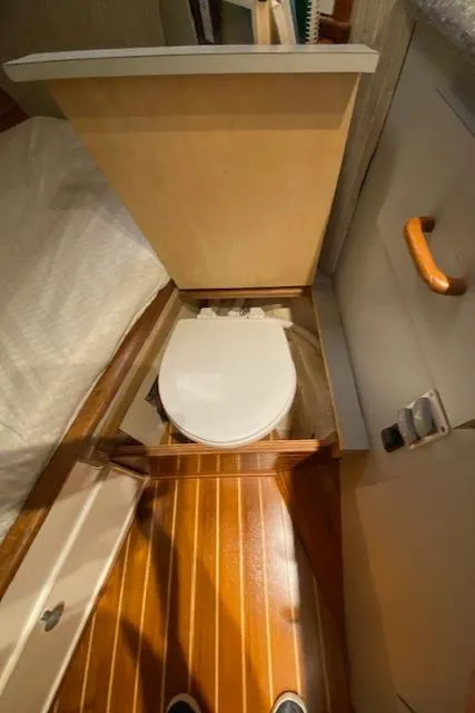 Slide: The Image of 1971 Matthews Motor Yacht bathroom with wooden flooring and compact toilet. - 50