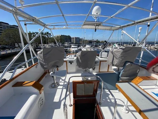 Slide: The Image of 1971 Matthews Motor Yacht deck with covered seats at marina. - 6