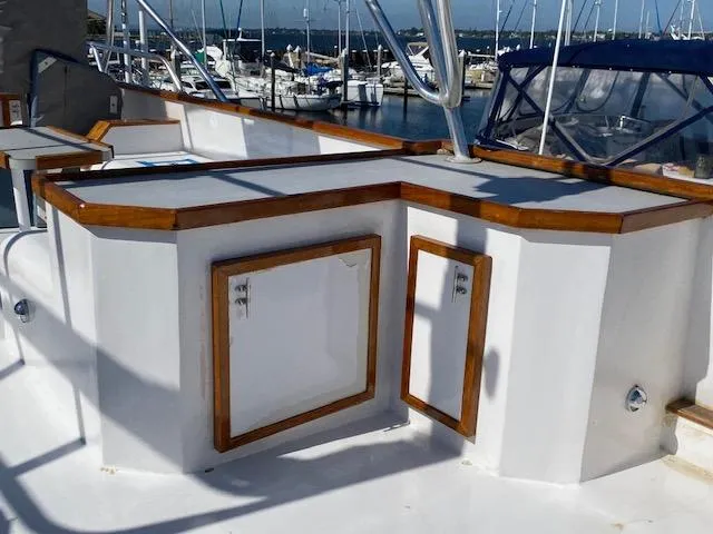 Slide: The Image of 1971 Matthews Motor Yacht deck with wooden trim and storage compartments. - 8
