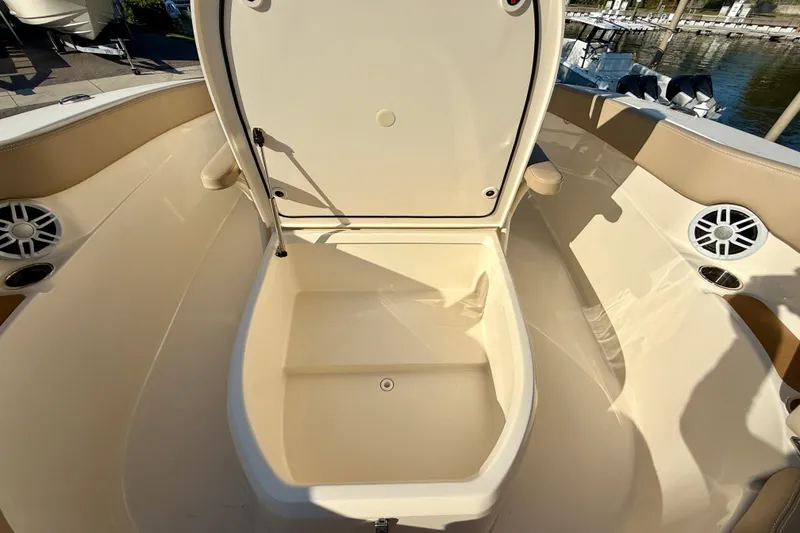 Slide: The Image of 2025 Scout 215 XSF boat interior with open storage compartment and speakers. - 15
