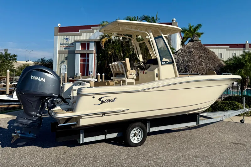 Slide: The Image of 2025 Scout 215 XSF boat with Yamaha engine on trailer, parked outdoors. - 2