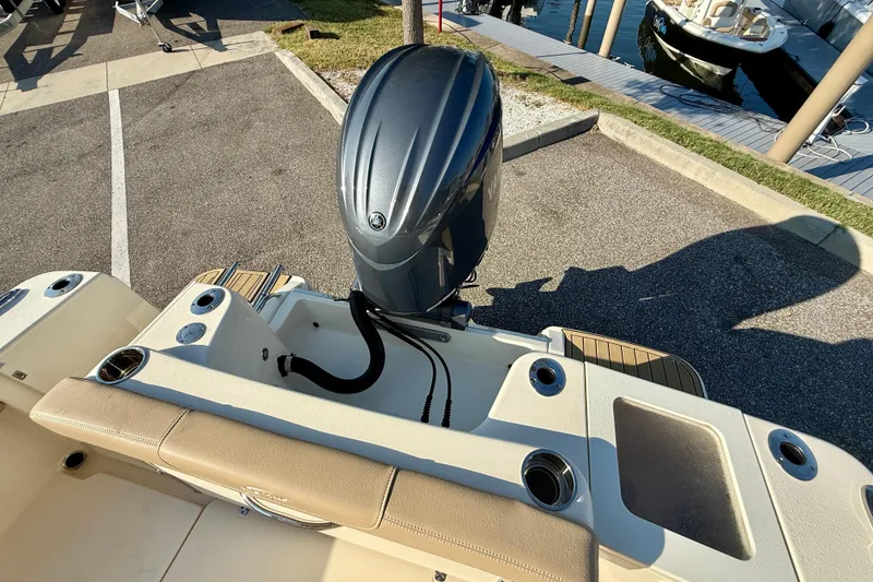 Slide: The Image of 2025 Scout 215 XSF boat with outboard motor at marina dock. - 5