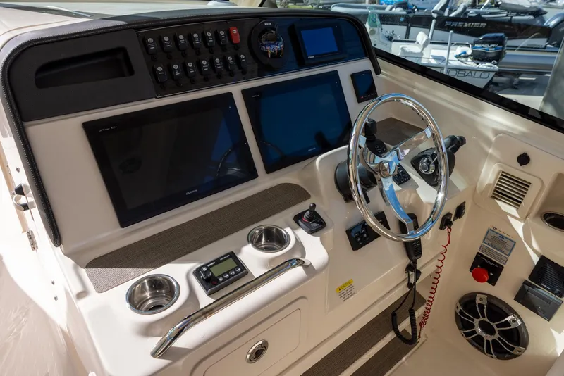Slide: The Image of 2019 Grady-White Freedom 375 boat dashboard with steering wheel and electronic displays. - 11