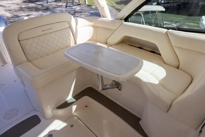 Slide: The Image of 2019 Grady-White Freedom 375 boat interior with beige seating and a foldable table. - 13