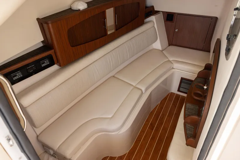 Slide: The Image of 2019 Grady-White Freedom 375 cabin interior with plush seating and wood accents. - 14