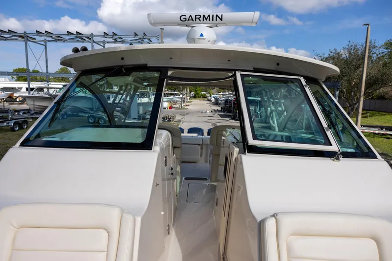 Slide: The Image of 2019 Grady-White Freedom 375 boat with Garmin radar, docked under blue sky. - 21