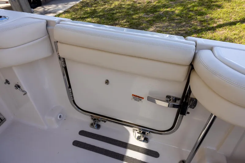 Slide: The Image of 2019 Grady-White Freedom 375 boat interior with white cushioned seating and safety gate. - 24
