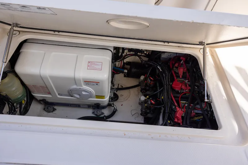 Slide: The Image of Engine compartment of 2019 Grady-White Freedom 375 boat, showing generator and wiring. - 26