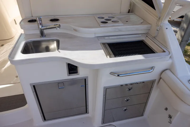 Slide: The Image of 2019 Grady-White Freedom 375 boat kitchenette with sink, grill, and storage drawers. - 7