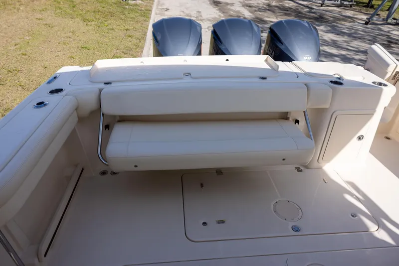 Slide: The Image of 2019 Grady-White Freedom 375 boat interior with seating and triple outboard motors. - 8