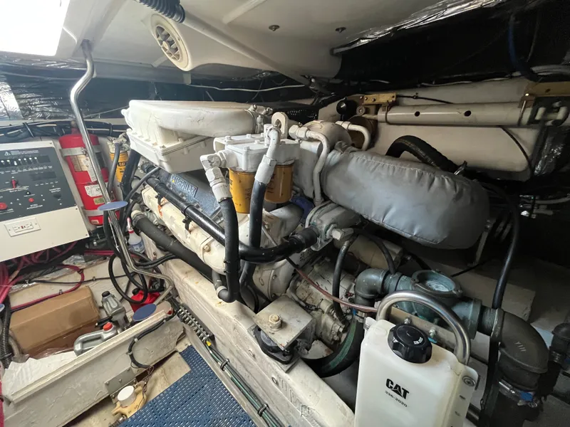 Slide: The Image of Engine room of 2001 Tiara Yachts 4100 Open, featuring CAT machinery and control panel. - 10