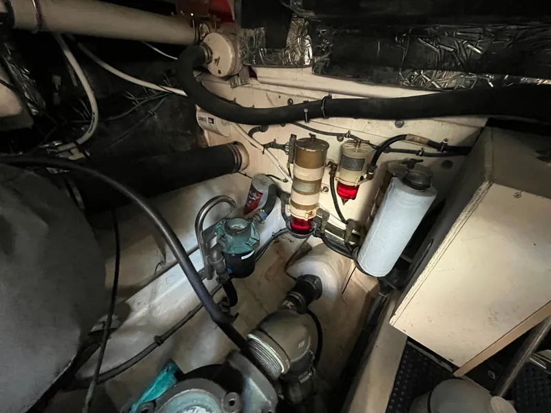 Slide: The Image of Engine room of a 2001 Tiara Yachts 4100 Open, showcasing mechanical components and filters. - 11