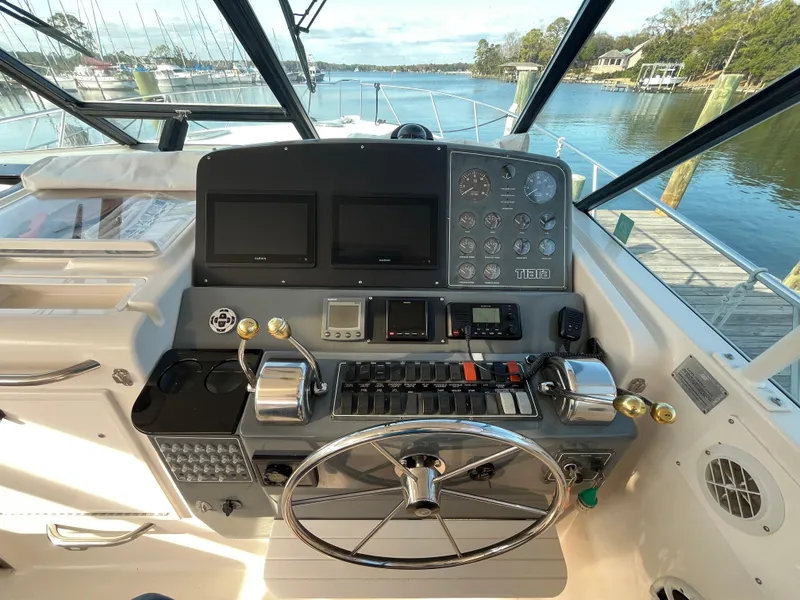Slide: The Image of Helm of 2001 Tiara Yachts 4100 Open with dual screens and controls. - 16