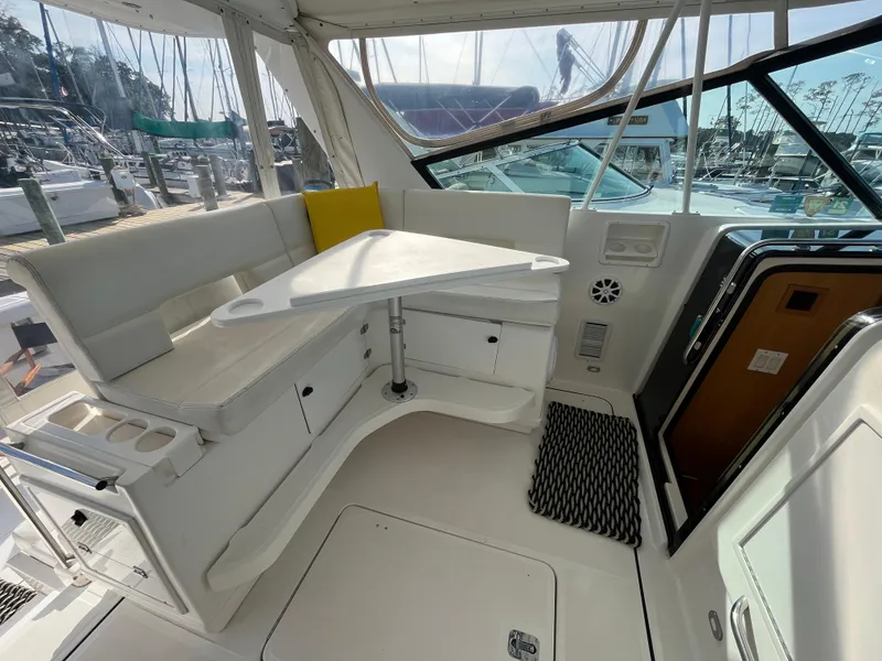 Slide: The Image of 2001 Tiara Yachts 4100 Open interior with seating and table, docked at marina. - 18