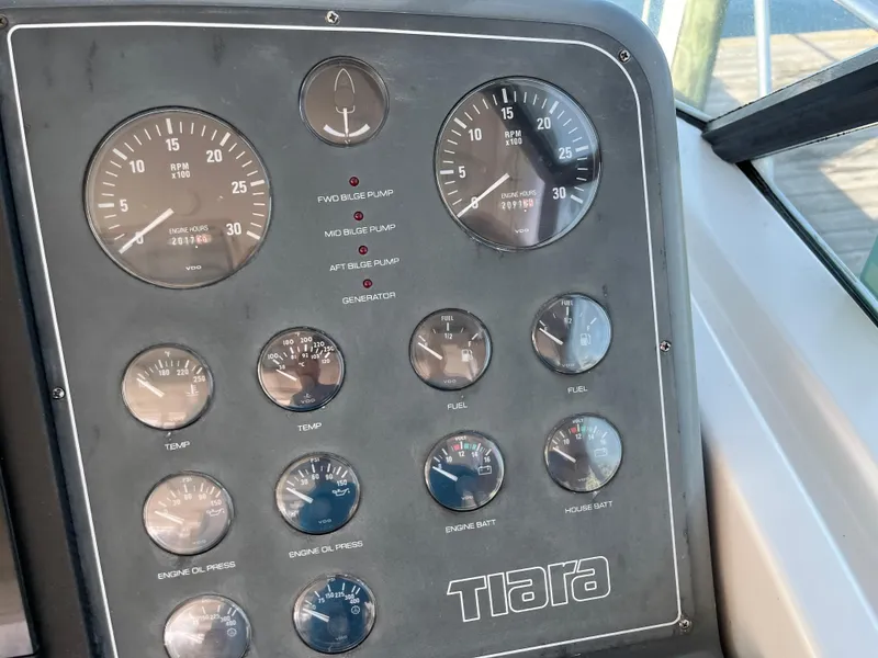 Slide: The Image of Dashboard of a 2001 Tiara Yachts 4100 Open, featuring various gauges and controls. - 19