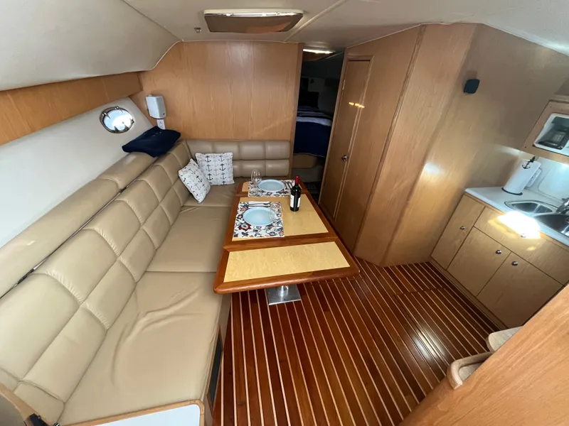 Slide: The Image of Interior of 2001 Tiara Yachts 4100 Open with elegant dining area and kitchenette. - 21